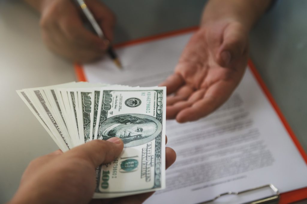 handing cash over in agreement of a contract